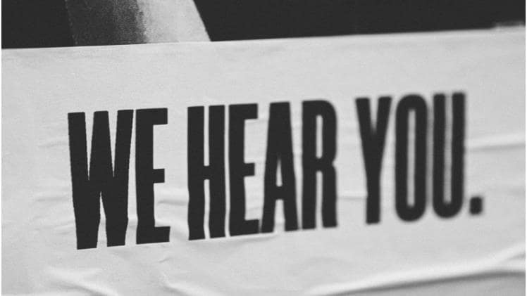 A picture of a banner that says, ‘We Hear You.’ Representing a key business approach taught by Bill Smith.
