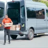 Delivery man unloading a delivery van